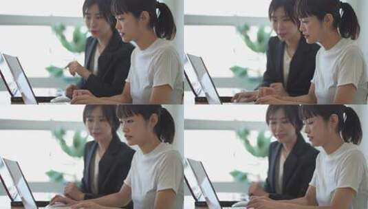 两个女人用电脑工作和讨论高清在线视频素材下载