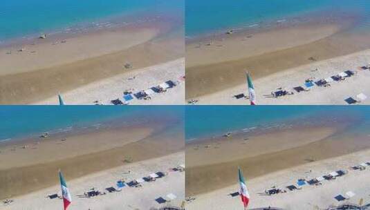 无人机飞回显示海滩和墨西哥国旗高清在线视频素材下载
