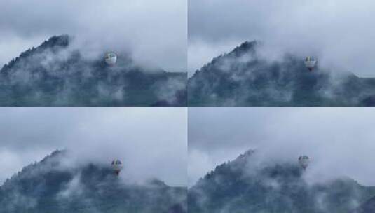 飞在云雾缭绕群山之中的热气球高清在线视频素材下载