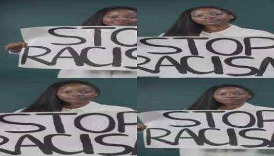 美丽的黑人女孩举着抗议标志停止种族主义高清在线视频素材下载