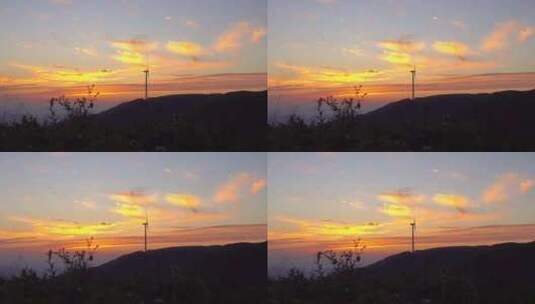 日落山顶转动的风力发电机剪影高清在线视频素材下载