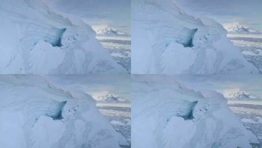 南极半岛白色冰川中的蓝色冰洞航拍特写高清在线视频素材下载