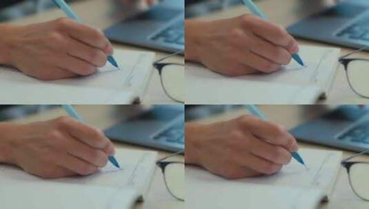 特写女性双手手臂在笔记本中书写笔记时间表高清在线视频素材下载