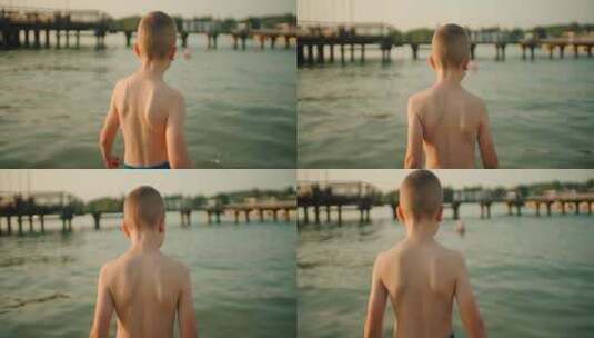 男孩在湖水中行走高清在线视频素材下载