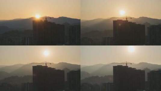 城市摩天大楼建筑工地塔式起重机上的日出。延时高清在线视频素材下载