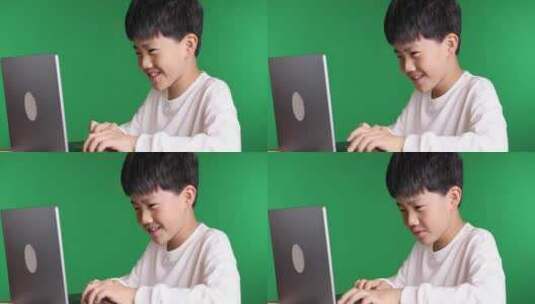 可爱的中国小男孩使用笔记本电脑8K实拍高清在线视频素材下载