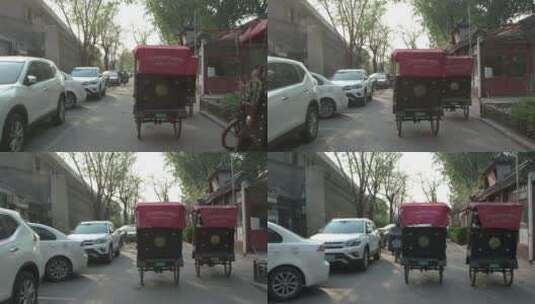 北京什刹海胡同旅游骑三轮车三轮车夫高清在线视频素材下载