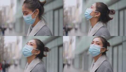 疫情期间城市街头戴口罩的女青年高清在线视频素材下载
