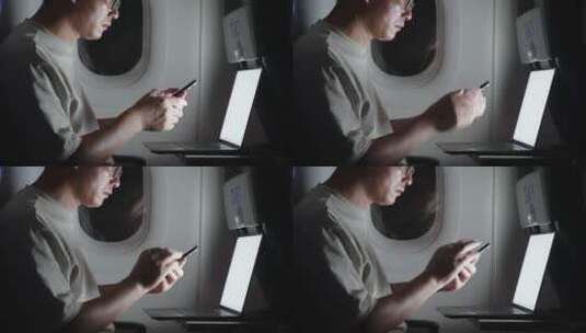 男子在飞机上用手机刷视频高清在线视频素材下载