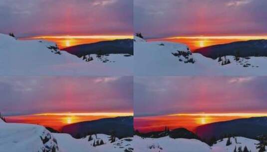 白雪覆盖的山峰，戏剧性的日落天空。加拿大高清在线视频素材下载