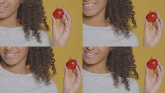 女人手持着番茄高清在线视频素材下载