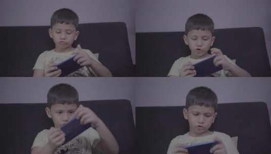 小男孩沙发上玩手机画面高清在线视频素材下载