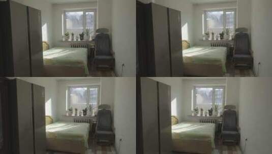 阳光照进放着绿植按摩椅床冰箱的卧室高清在线视频素材下载