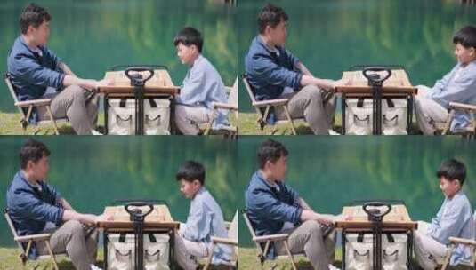 父子在湖边下棋 中国象棋 踏青 春游高清在线视频素材下载