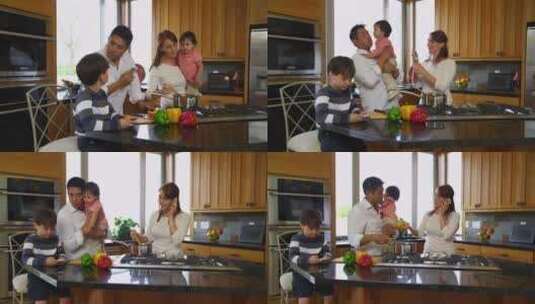 夫妇和他们的孩子在厨房做饭高清在线视频素材下载