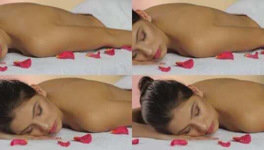 女孩水疗护理后在玫瑰花瓣毛巾上睡觉高清在线视频素材下载