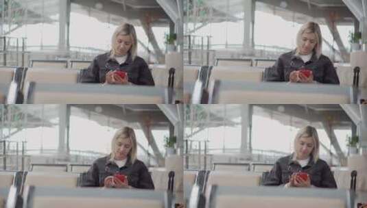 金发女郎在候机室玩手机高清在线视频素材下载