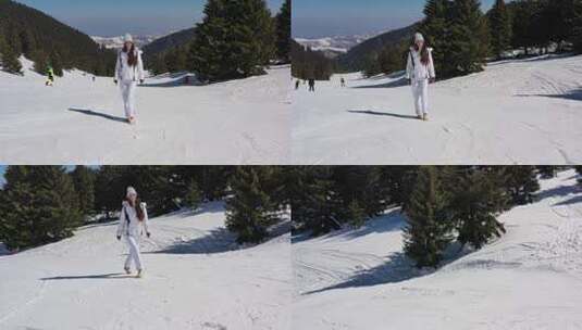 年轻女子走在雪山的滑雪道上高清在线视频素材下载