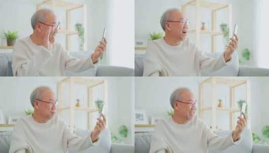 亚洲老年人在客厅使用手机进行视频通话。高清在线视频素材下载