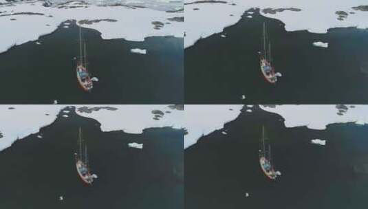 游艇航行在北极冰山海岸鸟瞰图高清在线视频素材下载