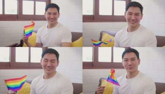 亚洲帅哥同性恋手持LGBT旗帜微笑的肖像高清在线视频素材下载