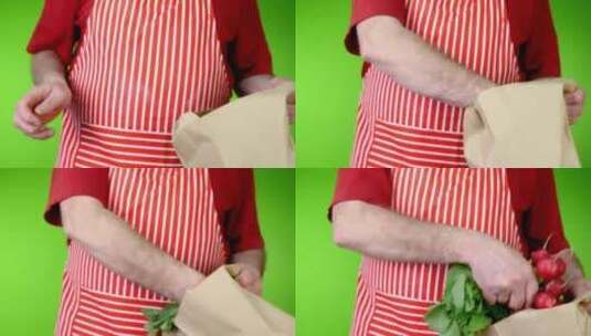 厨师从棕色纸袋里拿起鲜红色的新鲜萝卜高清在线视频素材下载