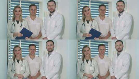 两个男医生和拿着听诊器微笑的女医生高清在线视频素材下载