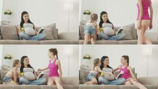孕妇和她的女儿坐在沙发上高清在线视频素材下载