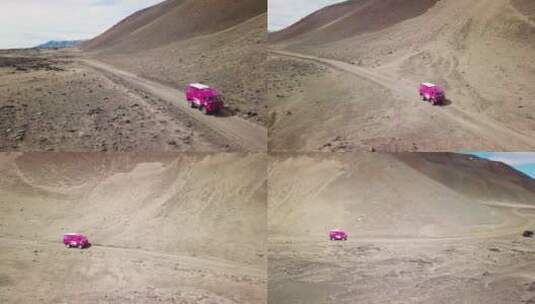航拍粉色路虎行驶在高地上高清在线视频素材下载