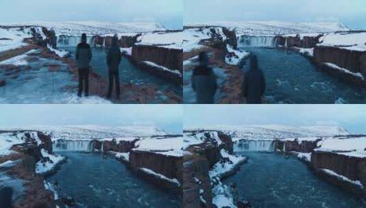 两个男人站在岸边欣赏冰川瀑布景观高清在线视频素材下载