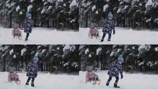 哥哥拉着坐在雪橇上的妹妹在雪地里行走高清在线视频素材下载