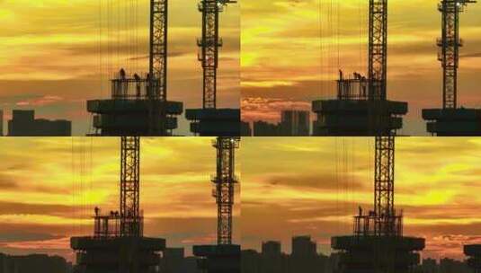 夕阳下塔吊作业工人施工剪影航拍高清在线视频素材下载