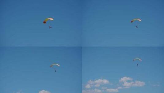 蓝天白云下的滑翔伞高清在线视频素材下载