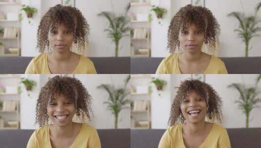 非裔妇女坐在沙发上对着镜头微笑高清在线视频素材下载
