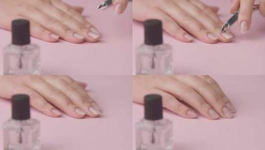 特写女人手放在粉色上为自己修指甲高清在线视频素材下载
