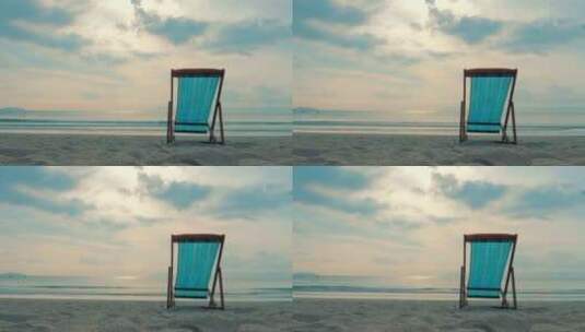 在热带海滩特写躺椅沙滩上，背景海和美丽的日落高清在线视频素材下载