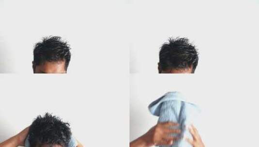 男人用毛巾擦干湿头发高清在线视频素材下载