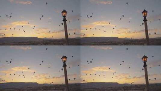 卡帕多西亚的大量热气球，太阳即将从山后升高清在线视频素材下载