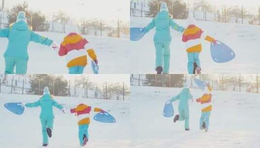 妈妈和女儿拿着雪盘在雪地里奔跑高清在线视频素材下载