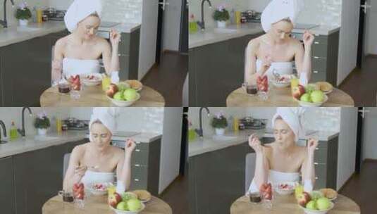 美丽女人坐在厨房里吃早餐高清在线视频素材下载