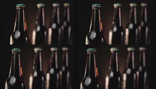 在深色背景上排成一排的冰镇啤酒瓶高清在线视频素材下载