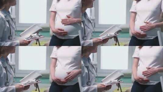 相机聚焦孕妇触摸腹部的手高清在线视频素材下载