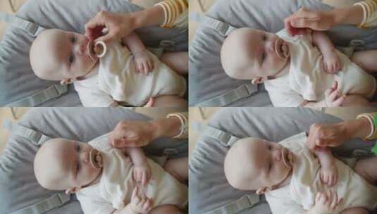 女人将奶嘴放入婴儿嘴里高清在线视频素材下载