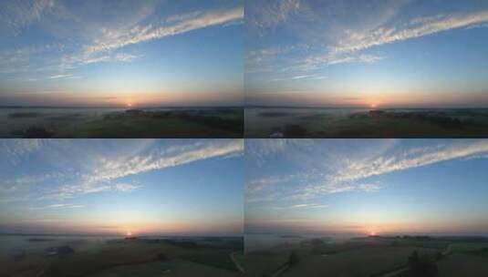 雾中田野和村庄上空太阳的缓慢空中拍摄高清在线视频素材下载