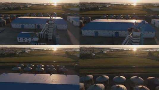 航拍日出时分的北大荒粮站粮仓库建筑高清在线视频素材下载