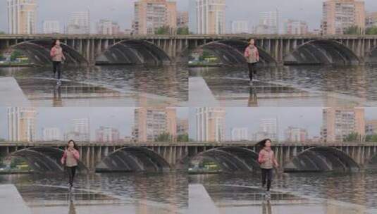 女人沿着河岸慢跑高清在线视频素材下载