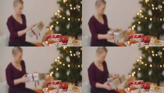 女人包装圣诞礼物模糊拍摄高清在线视频素材下载