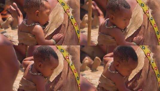 婴儿看非洲圣部落的火舞表演高清在线视频素材下载