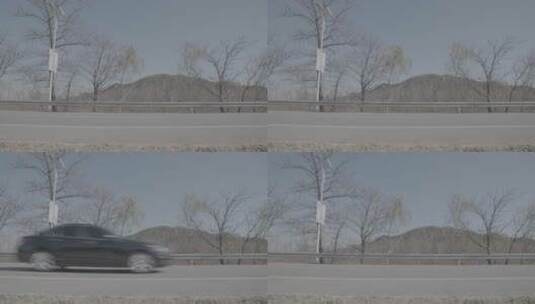 春季一辆黑色轿车从公路高速驶过高清在线视频素材下载