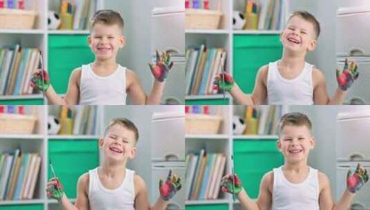 一个快乐的有创造力的小男孩正在用手指画画高清在线视频素材下载